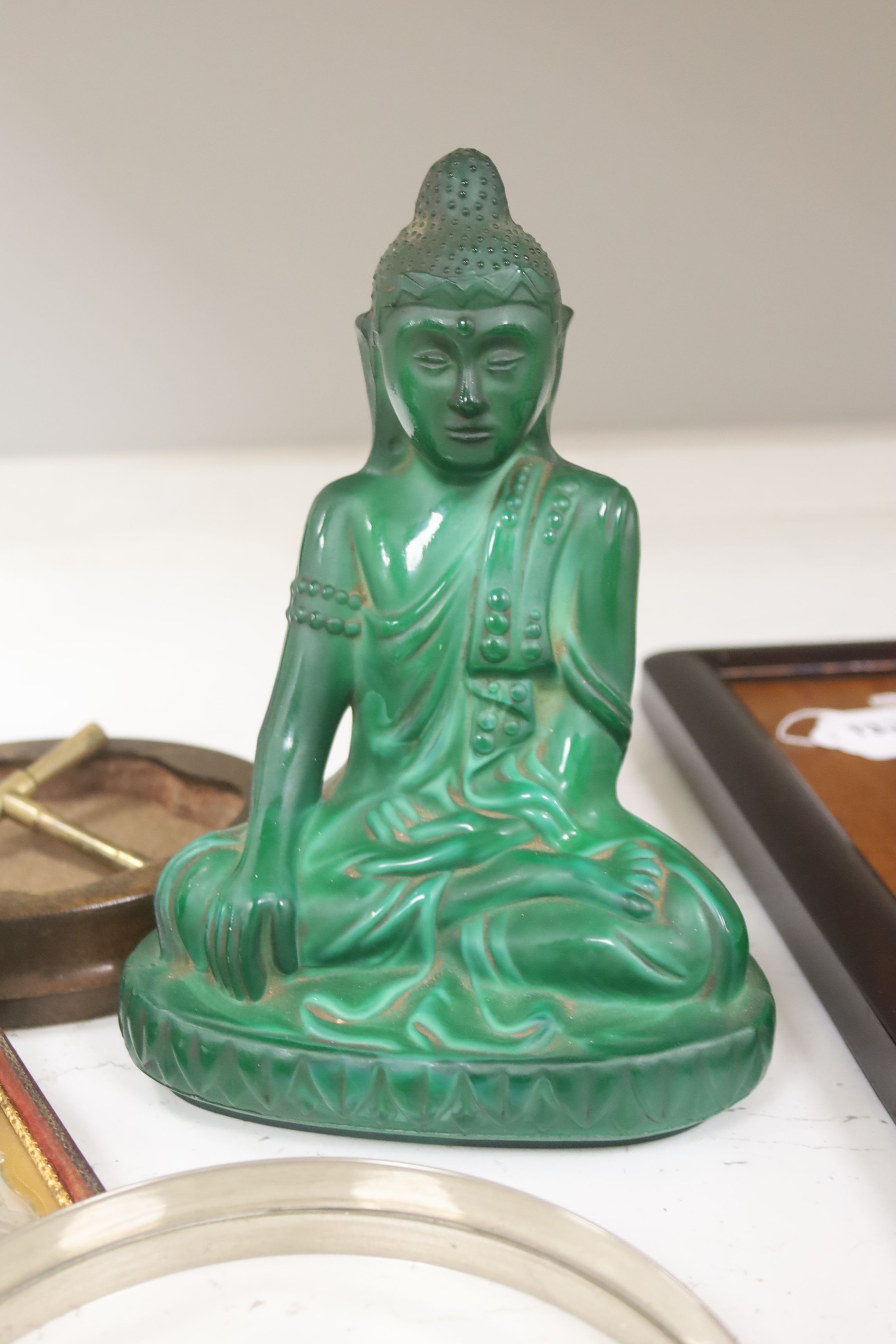 A French Art Deco green glass ashtray, a similar green glass Buddha, two magnifying glasses and a Daguerreotype portrait of a Victorian lady